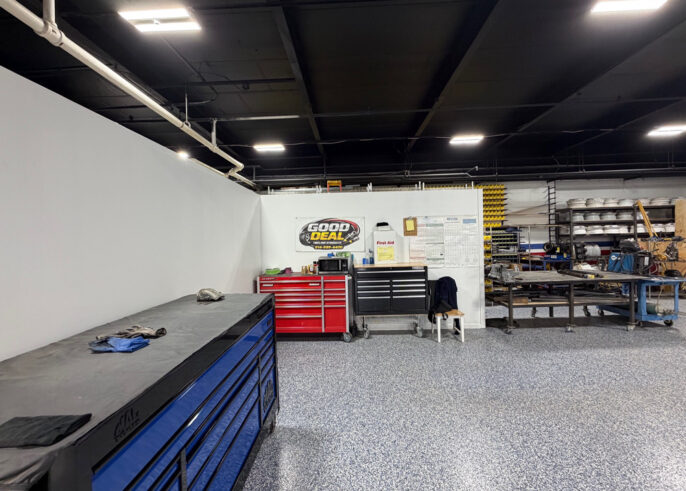 Side View & Sign inside of Good Deal Tires and Hydraulics shop
